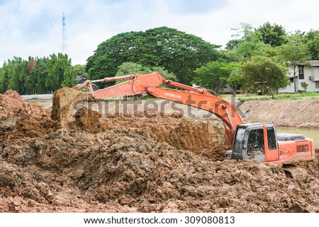 CHONBURI,THAILAND - AUGUST,23 : Backhoe on the construction at digging the pit. Preparatory work for the construction of grain silos in Cjpmbiro,Thailand on August 23,2015