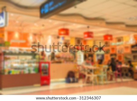 Blurred image people and food shops airport