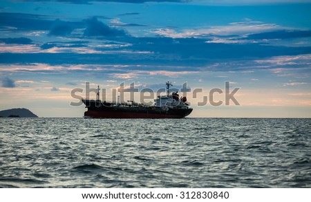 CHONBURI,THAILAND - SEPTEMBER 2 : The oil vessel is sailing in sea shore in twilight time on September 2, 2015 in Chonburi, Thailand