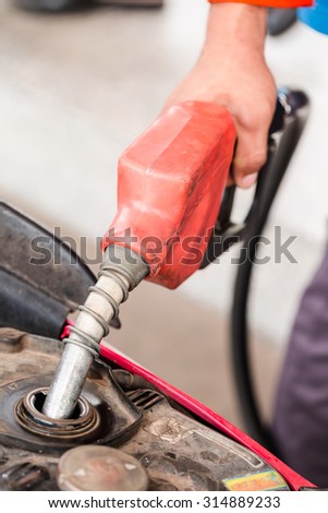 Closeup of pumping gasoline fuel into motorcycle tank