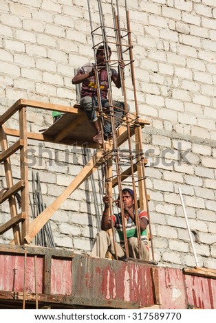 LEH LADAKH , INDIA - AUGUST 11 : The unidentified workers are working at new building site in Leh, Ladakh,India on August 11, 2015.
