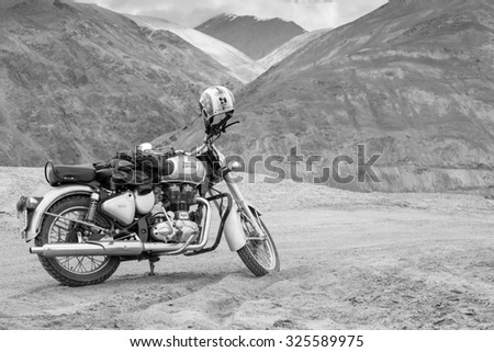 LEH LADAKH , INDIA - AUGUST 11 : The black and white photo of motorcycle is parking beside Pangong lake in summer in Leh Ladakh,India on August 11, 2015.