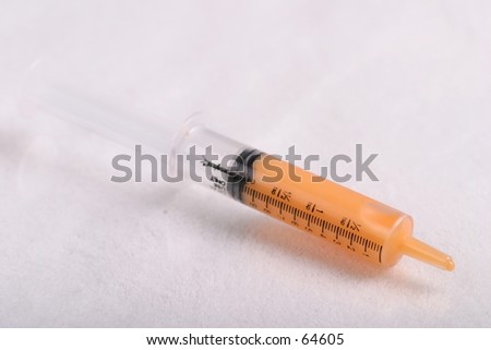 Orange Medicine in Syringe