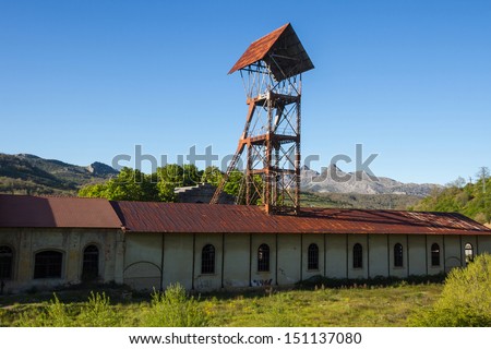 Pit Mine Headframe ( tower elevation ) of old hangar mine shaft and closed between trees  and vegetation highland . Sotillos . Leon . Spain
