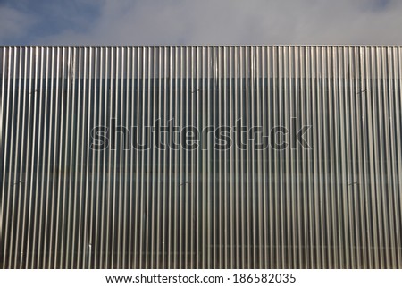 Structure and linear geometry of metal silver-gray lining building facade