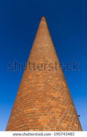 Old brick and tiles factory chimney built on bricks