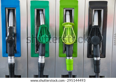 Four jet nozzles or hoses with tap for dispensing fuel at a gas station