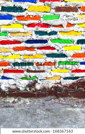 Colorful brick wall with cement floor - beautiful variety colors red green yellow blue cement pattern background