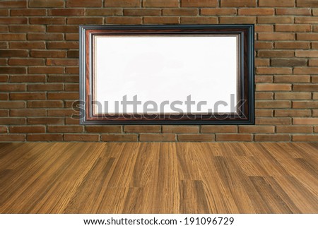 wooden picture frame on brick wall background and wooden floor