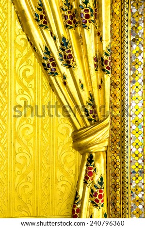 traditional Thai style art gold painting curtain pattern on wall in temple