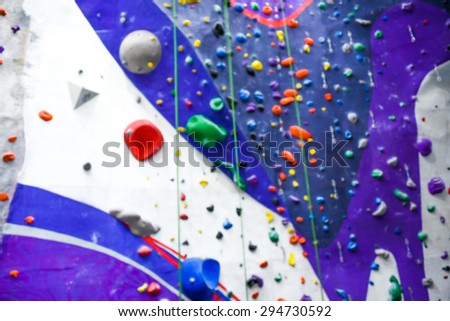 blurred image of indoor rock wall climbing