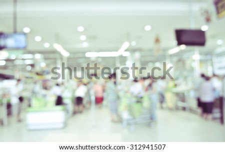 blurred image of supermarket - cashier counter customers