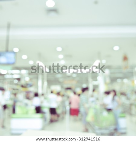 blurred image of supermarket - cashier counter customers