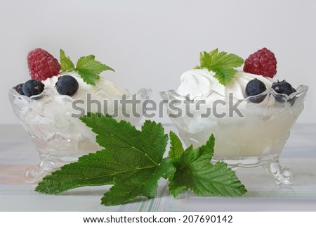 Two servings of vanilla ice cream with berries - stock photo