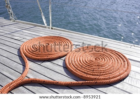 Coiled rope on a the deck of the sailboat.