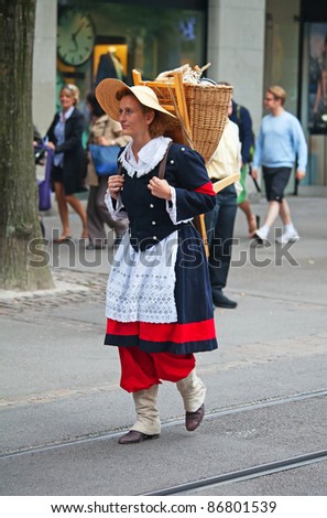 ZURICH - AUGUST 1: Woman in national costume taking part in Swiss National Day parade on August 1, 2011 in Zurich, Switzerland.