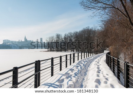 The trail along Ottawa river under the snow with a sunny blue sky