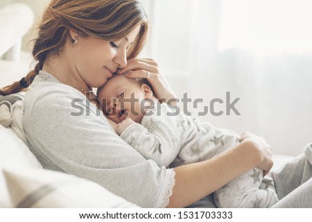 Similar – Image, Stock Photo A young mother and her little daughter together water the plants in the greenhouse. Childhood, parenting, upbringing