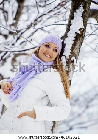 Portrait of cute young woman walking outdoors in winter