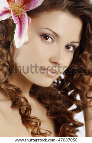 Portrait of very cute young woman with healthy curly hair