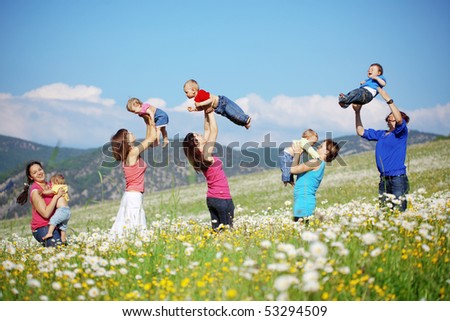 Mothers with children in flower field