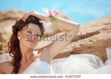 Beautiful bride posing at sea coast