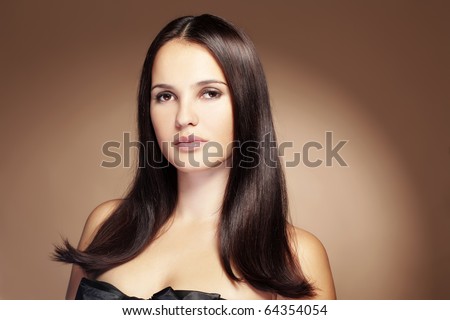 Portrait of young beautiful woman with long glossy hair