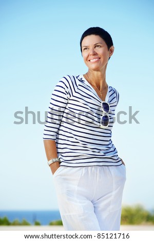 Portrait of beautiful middle aged woman outdoors