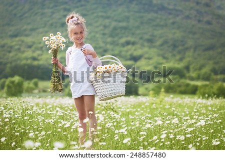 7 years old child having fun in flower field
