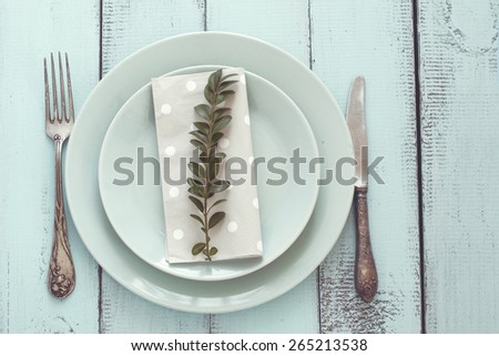 Spring shabby chic table setting on mint wooden background, top view point