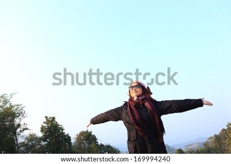 Happy  free woman enjoying nature. Freedom and serenity concept with female model in ecstatic enjoyment. Mixed race Asian Caucasian female model in 40 enjoying outdoor style, north in Thailand