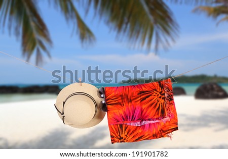 Straw hat,  sun glasses on a tropical beach