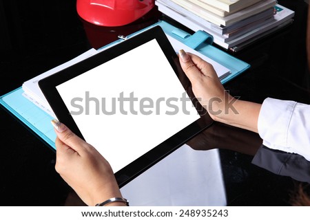 tablet pc in hand on office table