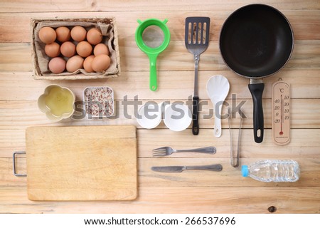 Cooking concept. Basic baking ingredients and kitchen set on wood table