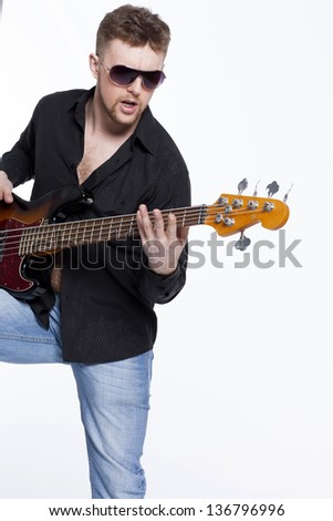 Bass player with attitude playing guitar gently in love with music