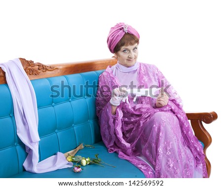 Woman in violet dress sitting on the sofa