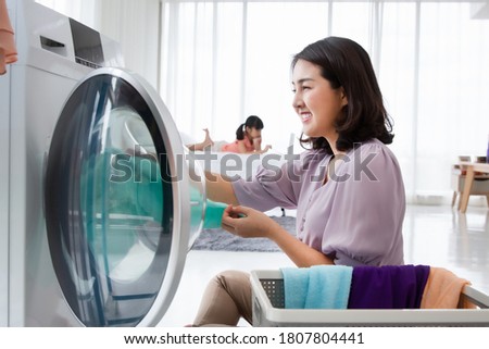 Similar – Image, Stock Photo Mother doing the laundry together with her young child