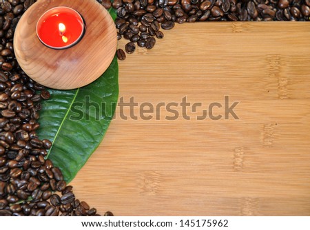 wooden table with round candle coffee beans