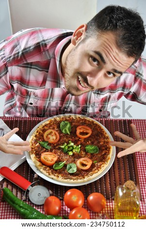 Crazy hungry man eating pizza in a restaurant