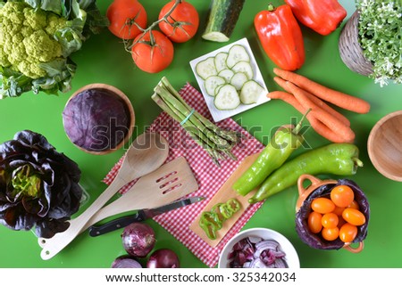 various types of fresh vegetables like tomatoes , red onions, green peppers and red