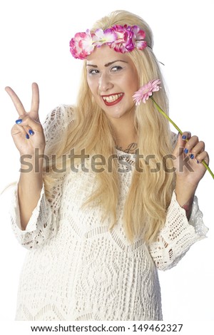 Woman in hippie look with very fair hair wear summer clothes, a floral wreath and hold a pink gerbera. The person is exempted on white background.