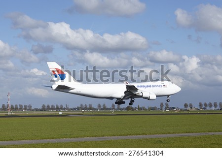 AMSTERDAM, THE NETHERLANDS - MAY, 7. A Boeing 747-4H6F of MAS-Cargo (Malaysia Airlines Cargo) lands at Amsterdam Airport Schiphol (The Netherlands, AMS) on May 7, 2015. The runway is the Polderbaan.