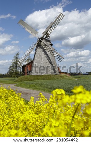 The windmill Bierde (Petershagen, Germany) is a dutch type of windmill and is part of the Westphalia Mill Street (Westfaelische Muehlenstrasse). The foreground is a yellow blossoming field of canola.
