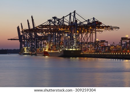 HAMBURG, GERMANY - AUGUST, 22. The container vessel Eilbek is loaded and unloaded at the terminal Burchardkai in the deepwater port Hamburg Waltershof (Germany) in the evening on August 22, 2015.