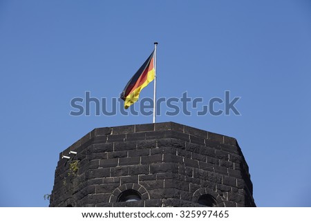 REMAGEN, GERMANY - AUGUST, 31. The flag of Germany blows on the tower of The Remagen Bridge (Germany, Rhineland-Palatinate, administrative district Ahrweiler) on August 31, 2015.