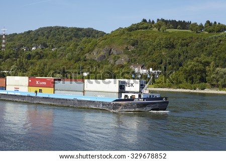 DATTENBERG, GERMANY - AUGUST, 31. The vessel Joline II with some containers on the Rhine river near Dattenberg (Germany, Rhineland Palatinate, district Neuwied) photographed on August 31, 2015.