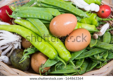 Vegetables and egg . Fresh Bio Vegetable in a Basket. Over Nature Background