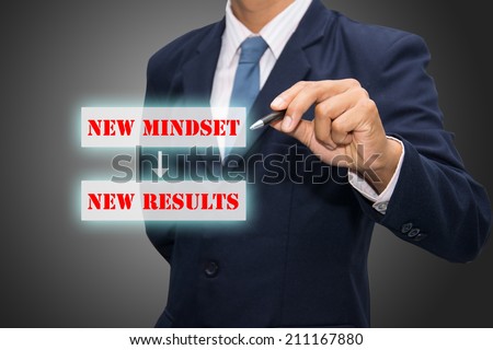 Business man hand writing New Mindset New Results
