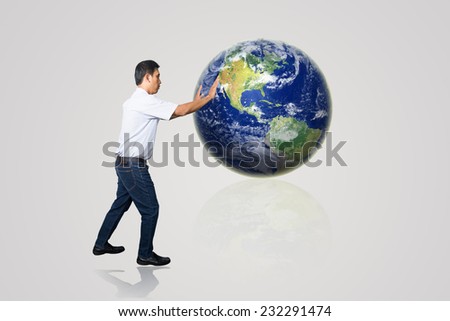 Image of young businessman under pressure of planet Earth. Elements of this image are furnished by NASA
