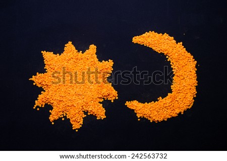 Moon and sun or star are made from orange lentils